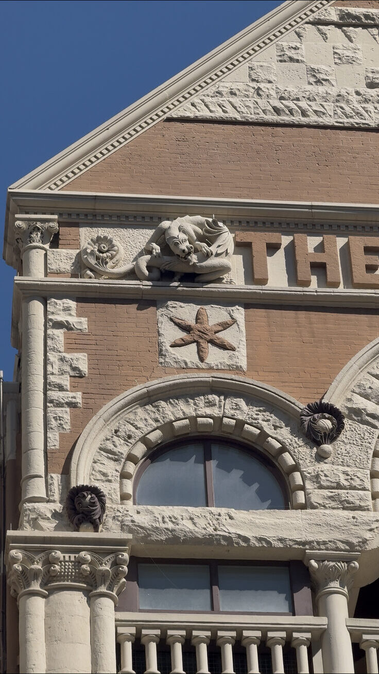 Stone dragon carving on a historic building